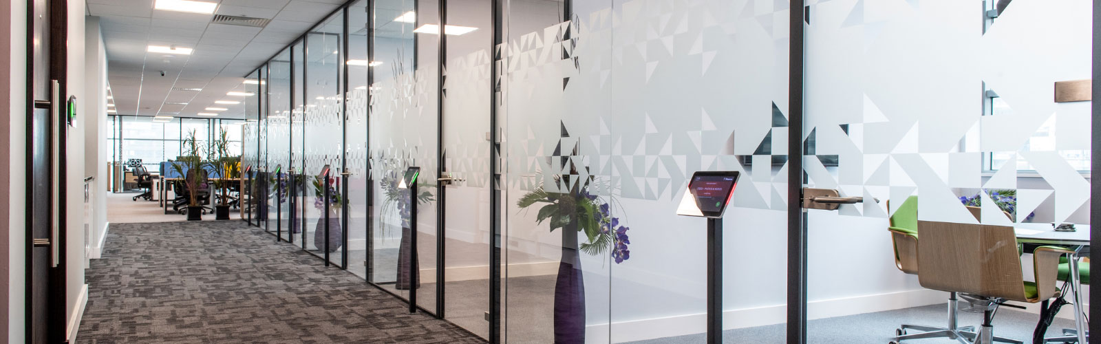 Modern office corridor with conference rooms using technology 