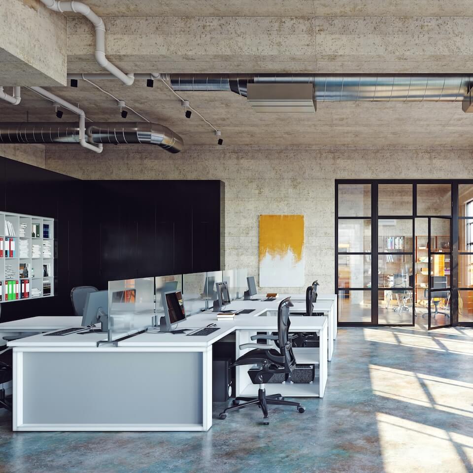 A modern office design with large windows, concrete floor, white desks and black chairs