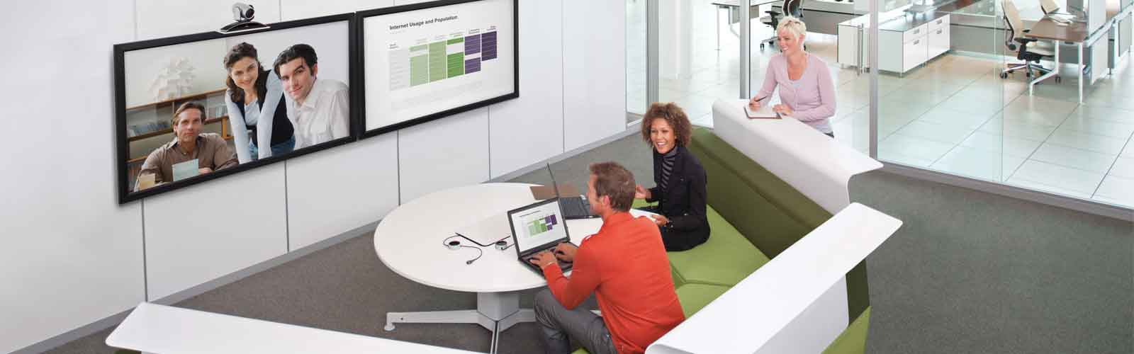 Colleagues using video conferencing technology, connecting with remote workers