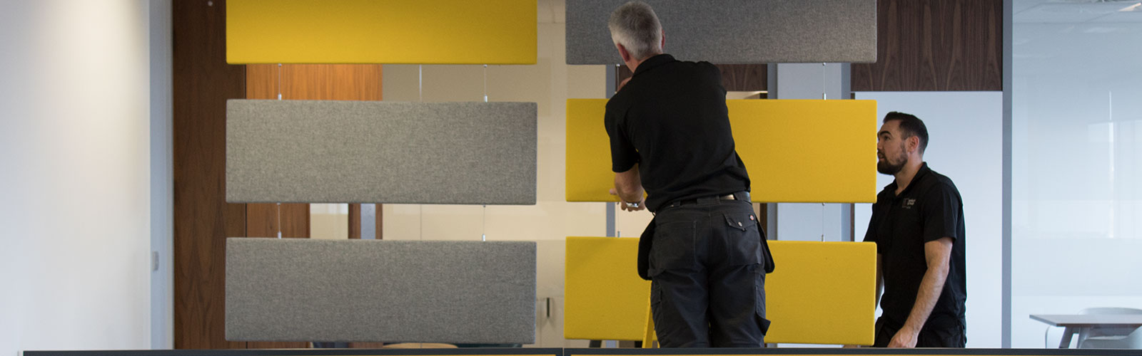 Penketh Group office fit out experts installing yellow and grey furniture