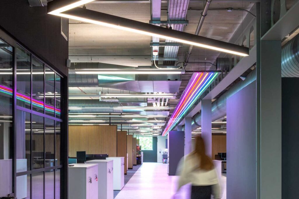 Gaming software company interior design with pink and purple neon lights along the ceiling