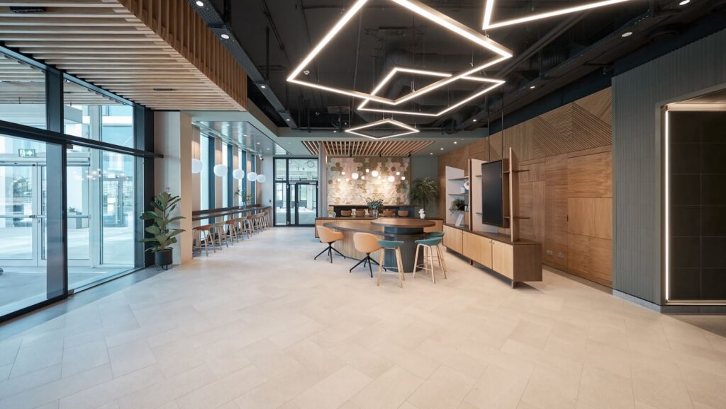 Modern office with glass walls and contemporary geometric lights 