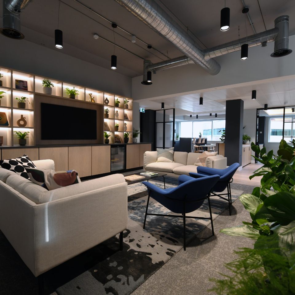 Bright hospitality-inspired office space with plants and modern decor