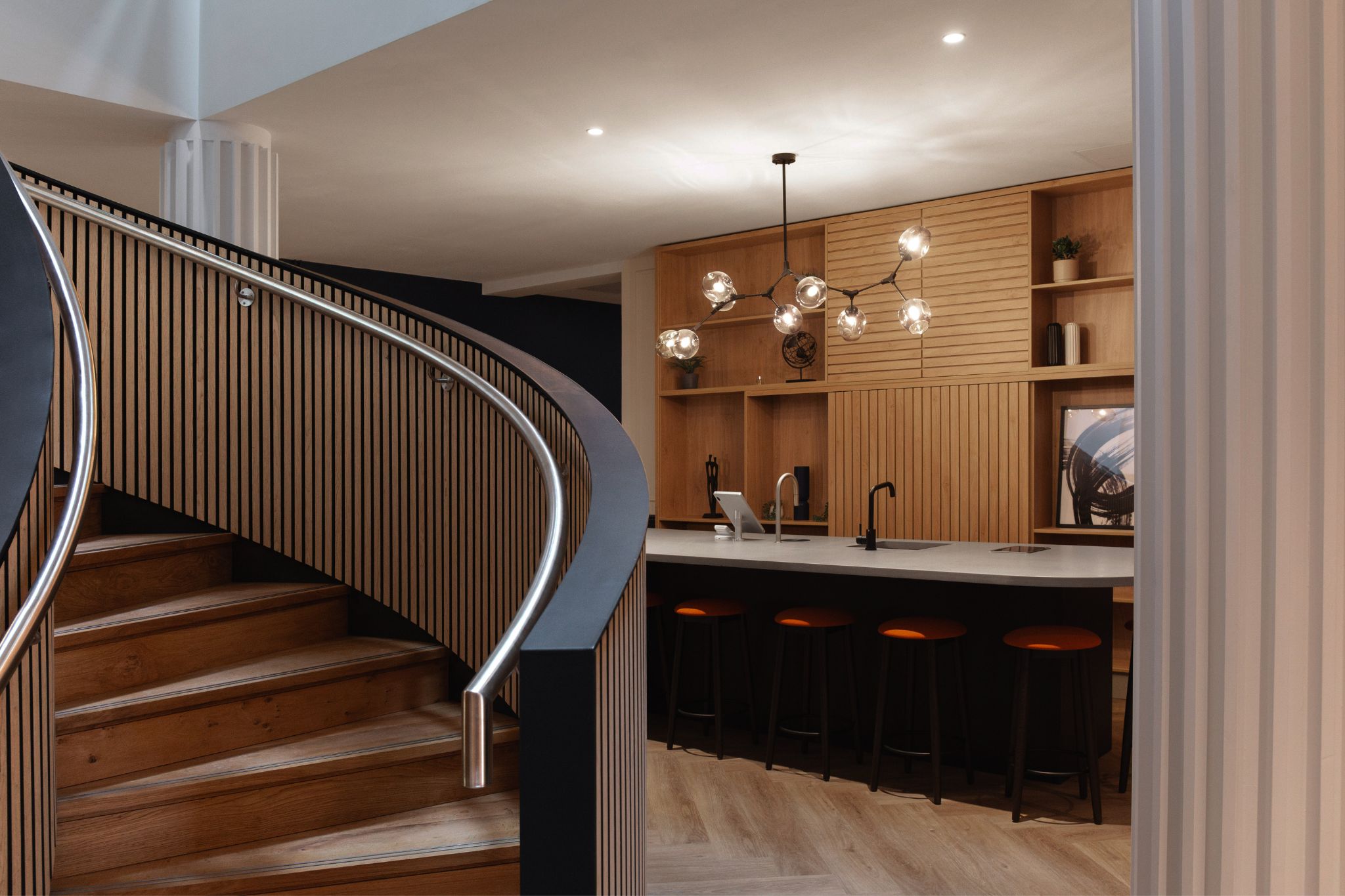 Bespoke staircase in the middle of a hospitality inspired office common area