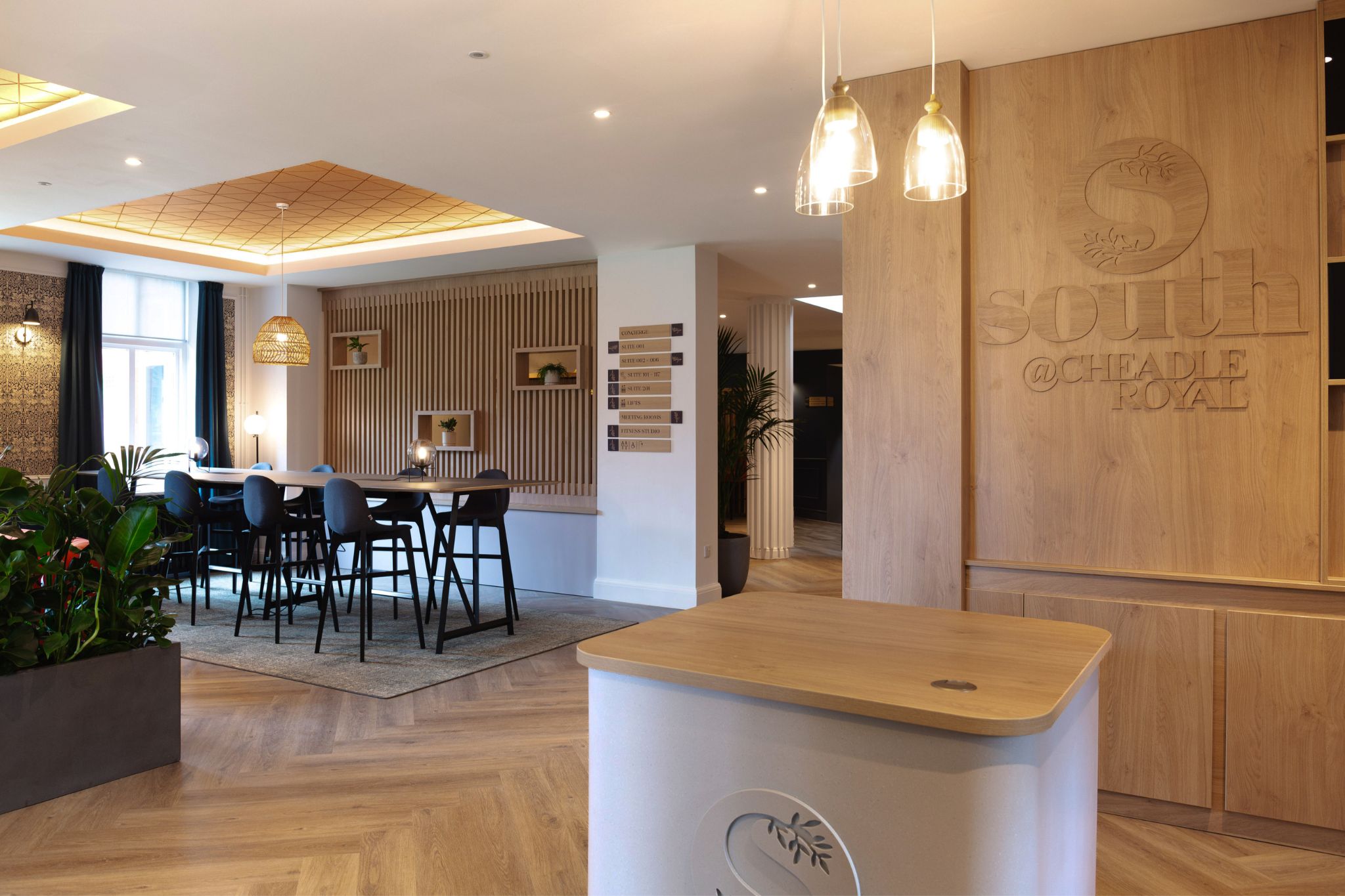 Hospitality-inspired wooden and modern work reception area with high-desk and seating