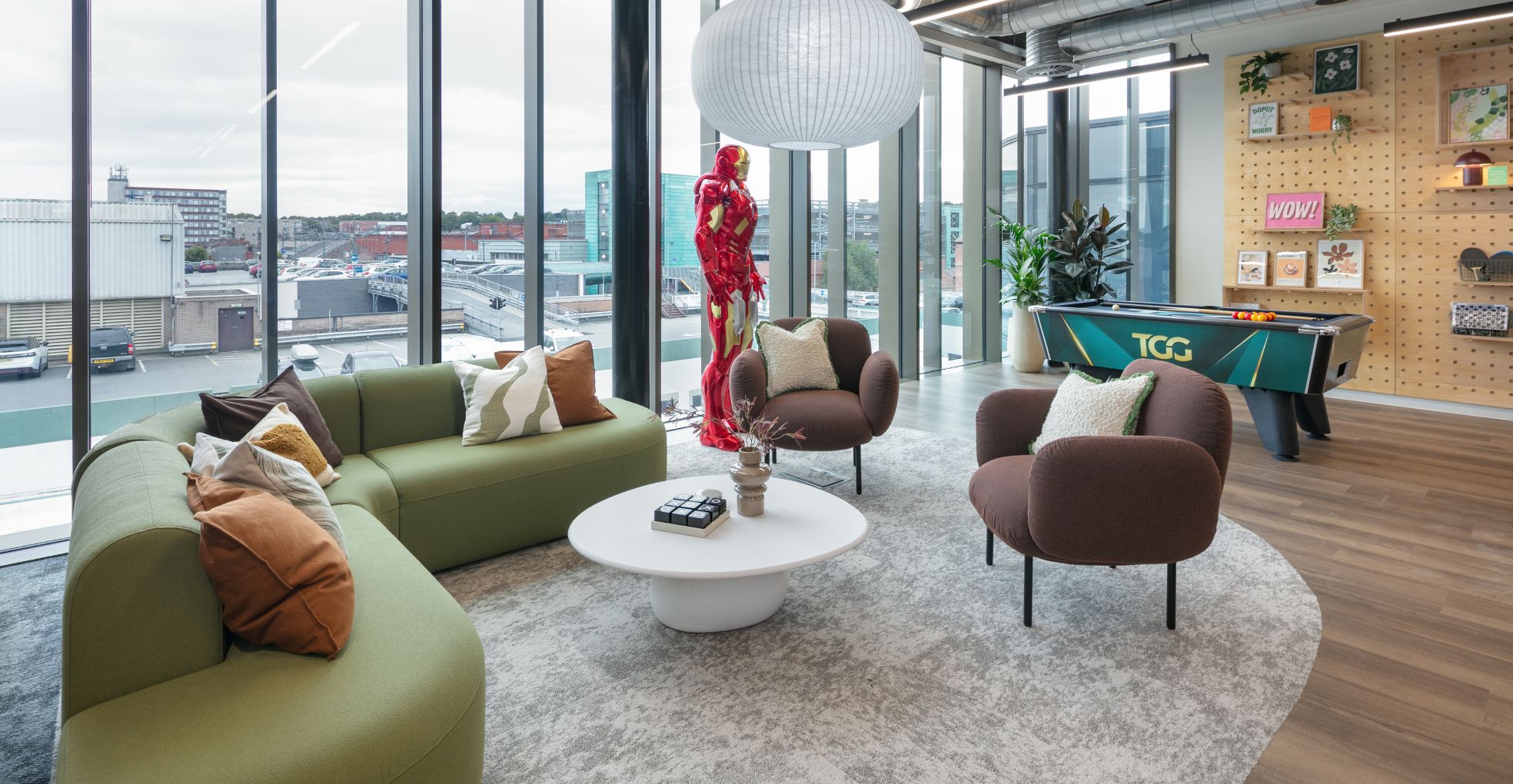 Modern workcafé with brand focused decor, soft seating and a pool table